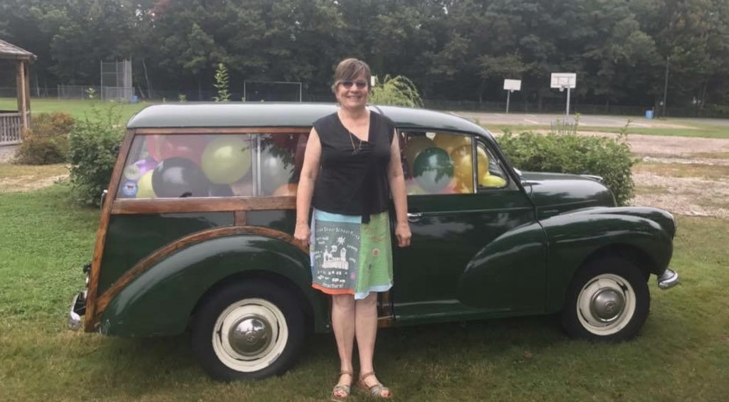 Gwen in front of car