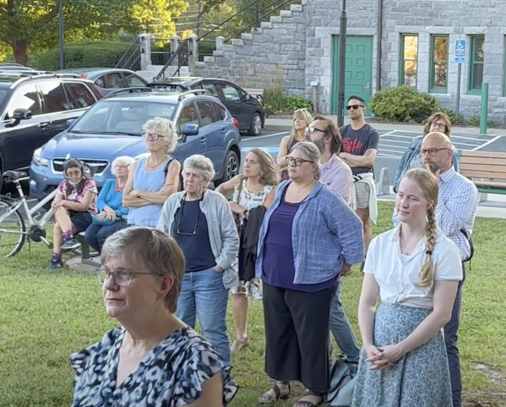 Folks on the lawn listening to gwen talking.