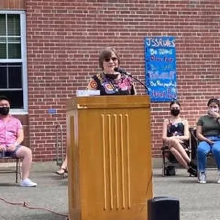 Gwen at a podium